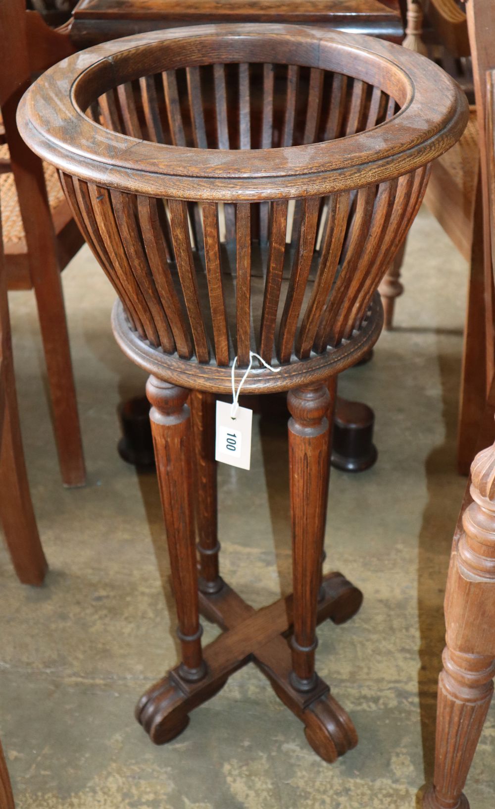 A 1920s mahogany jardiniere, 39cm diameter, H.82cm